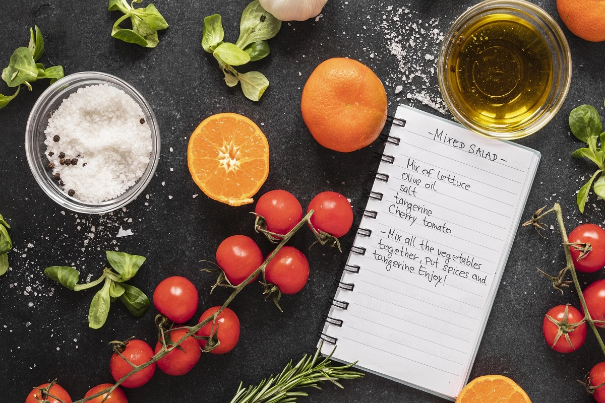 Open recipe binder with colorful dividers in a well-organized kitchen setting.