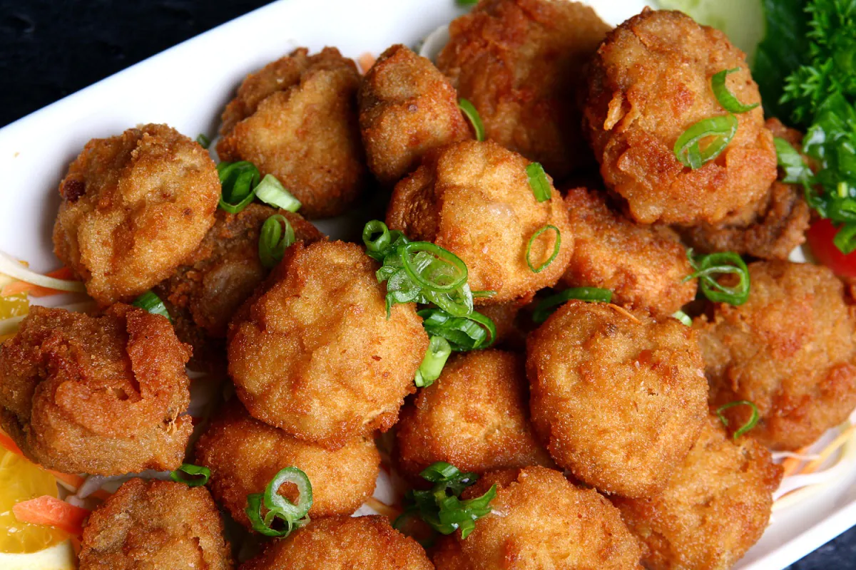 Platter of Red Lobster Sausage Balls with fresh garnish and dipping sauce